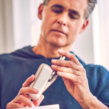 Person holding an IQOS device.