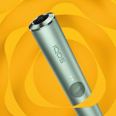 A jade green IQOS ILUMA PRIME device.