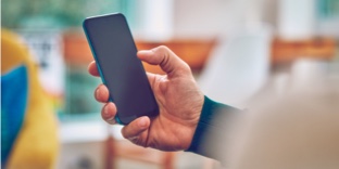 A mobile phone in a person's hand.
