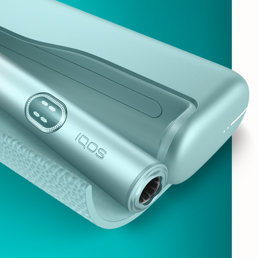 Blue IQOS ILUMA i PRIME device inside its charger - detail