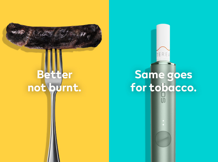 Burnt sausage on a fork compared to IQOS TEREA stick in an IQOS ILUMA holder.