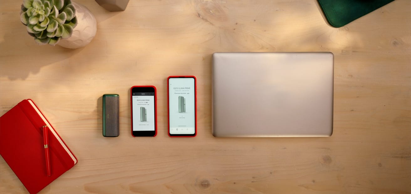 A laptop computer and two mobile devices showing the IQOS app.
