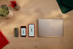 A laptop computer and two mobile devices showing the IQOS app.