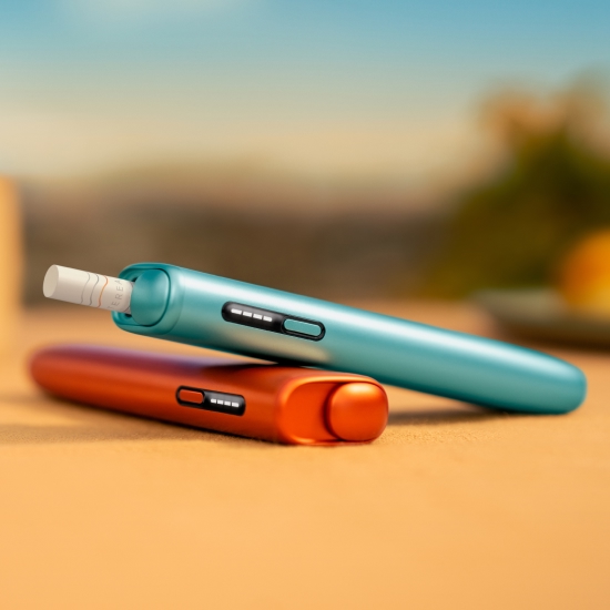 Blue IQOS ILUMA i ONE above a terracotta IQOS ILUMA i ONE