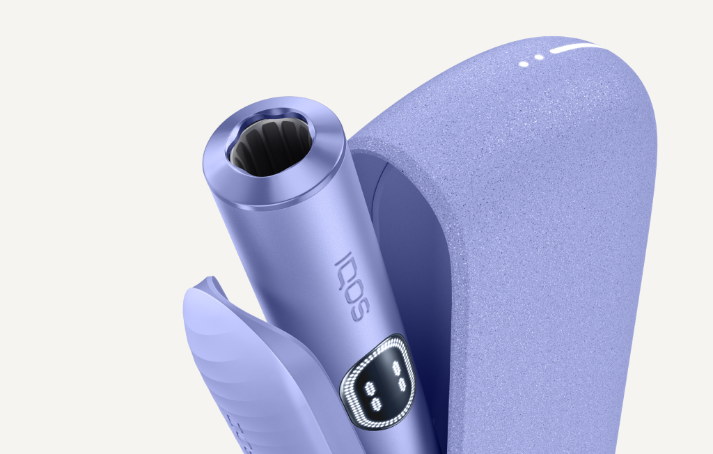 Violet IQOS ILUMA i device inside its opened charger