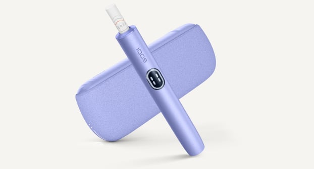 Violet IQOS ILUMA i device above its charger