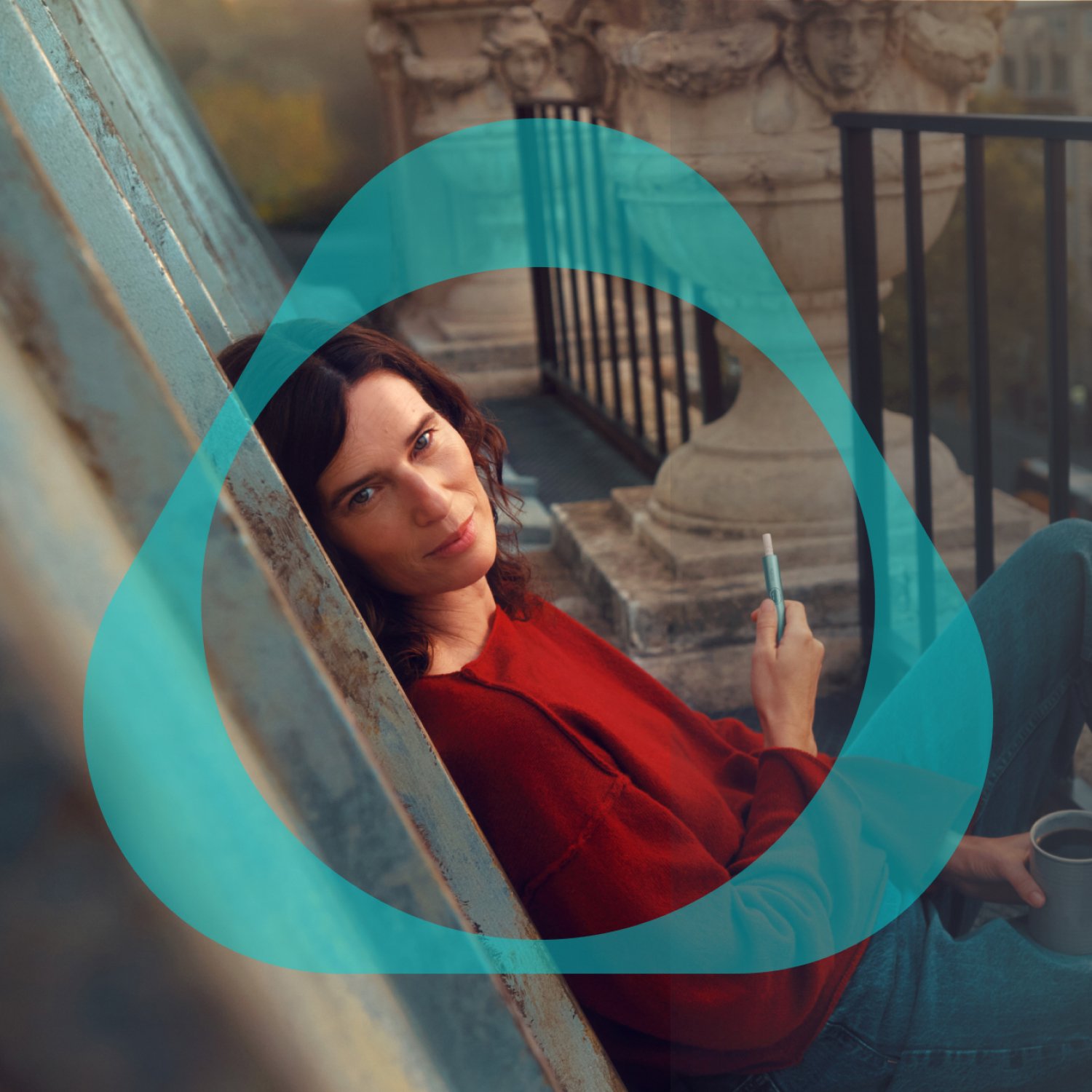 City balcony scenary - Woman holding IQOS device - with IQOS logo